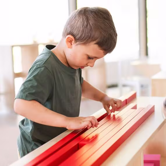 Group of small nursery school children playing indoors