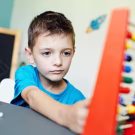 Schoolboy learning with an abacus